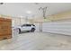 Spacious two car garage featuring a new SUV and refrigerator at 6841 W Glory Maple Dr, McCordsville, IN 46055