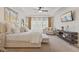 Bright main bedroom featuring a ceiling fan, neutral decor, sitting area, and large windows with natural light at 6841 W Glory Maple Dr, McCordsville, IN 46055