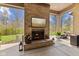 Cozy outdoor fireplace with a brick surround and a view of the landscaped backyard at 6841 W Glory Maple Dr, McCordsville, IN 46055