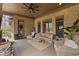 Covered patio with comfortable seating, brick walls, and view of the yard at 6841 W Glory Maple Dr, McCordsville, IN 46055