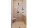 Shower featuring neutral tile, rainfall shower head, and integrated shelving at 6841 W Glory Maple Dr, McCordsville, IN 46055