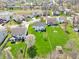 Aerial view of the home featuring a spacious backyard, mature trees and a neighborhood pond at 7354 Ponderosa Pines Ln, Indianapolis, IN 46239