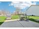 Backyard featuring a concrete patio with outdoor seating, a grill, and a spacious lawn at 7354 Ponderosa Pines Ln, Indianapolis, IN 46239
