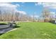 Backyard featuring a green lawn, mature trees, and a patio with outdoor seating at 7354 Ponderosa Pines Ln, Indianapolis, IN 46239