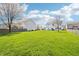 Spacious backyard featuring lush green grass and mature trees, perfect for outdoor activities at 7354 Ponderosa Pines Ln, Indianapolis, IN 46239