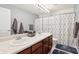 Bathroom featuring double sinks, a large mirror, and a shower with a patterned curtain at 7354 Ponderosa Pines Ln, Indianapolis, IN 46239