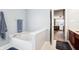 Bathroom featuring a soaking tub, tile flooring, and modern fixtures at 7354 Ponderosa Pines Ln, Indianapolis, IN 46239