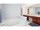 Bathroom featuring a soaking tub, dual sinks, and modern vanity with make up counter at 7354 Ponderosa Pines Ln, Indianapolis, IN 46239