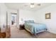 Cozy bedroom featuring carpeted floors, a comfortable bed, and an adjacent hallway at 7354 Ponderosa Pines Ln, Indianapolis, IN 46239