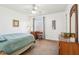 Bright bedroom featuring a ceiling fan, a wood desk, and a window with natural light at 7354 Ponderosa Pines Ln, Indianapolis, IN 46239