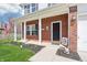 Inviting front porch with brick columns, a decorative wreath and a welcome sign at 7354 Ponderosa Pines Ln, Indianapolis, IN 46239