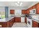 Kitchen featuring dark cherry cabinets, stainless steel appliances, and ample counter space at 7354 Ponderosa Pines Ln, Indianapolis, IN 46239