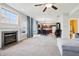 Living room with a fireplace, large windows and seamless transition to the kitchen and dining area at 7354 Ponderosa Pines Ln, Indianapolis, IN 46239