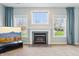 Cozy living room with fireplace, big windows for sunlight, and modern television set at 7354 Ponderosa Pines Ln, Indianapolis, IN 46239