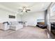 Open living room featuring a large sectional, ceiling fan, fireplace and neutral decor at 7354 Ponderosa Pines Ln, Indianapolis, IN 46239