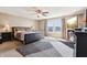Main bedroom with a ceiling fan, large window, and plush carpeting offers a relaxing retreat at 7354 Ponderosa Pines Ln, Indianapolis, IN 46239