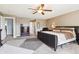 Main bedroom with ceiling fan, dark wood dresser, and plush carpeting offers a relaxing retreat at 7354 Ponderosa Pines Ln, Indianapolis, IN 46239