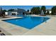 Sparkling community swimming pool with lounge chairs and umbrellas on a sunny day at 7354 Ponderosa Pines Ln, Indianapolis, IN 46239