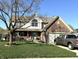 Charming two-story home with a brick and siding facade, attached garage, and well-maintained front yard at 7354 Samuel Dr, Indianapolis, IN 46259