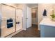 Bright bathroom featuring a modern shower with glass doors and vanity with white countertop at 7628 Big Bend Blvd, Camby, IN 46113