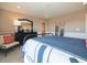 Cozy bedroom with bed, accent chair, dark wood dresser, and decorative touches at 7628 Big Bend Blvd, Camby, IN 46113