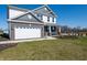 A two-story home with a brick and siding exterior, two-car garage and well-manicured lawn at 7628 Big Bend Blvd, Camby, IN 46113