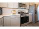 Close up of kitchen with stainless steel appliances and sleek gray cabinets at 7628 Big Bend Blvd, Camby, IN 46113