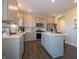 Well-lit kitchen features stainless steel appliances, gray cabinets, ample counter space and island with seating at 7628 Big Bend Blvd, Camby, IN 46113