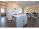 Kitchen island with countertop and gray cabinets that opens to the breakfast nook and living room at 7628 Big Bend Blvd, Camby, IN 46113