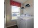 Laundry room with modern washer and dryer, featuring a window with valance at 7628 Big Bend Blvd, Camby, IN 46113