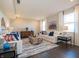 Open-concept living room featuring hardwood floors, white sofas, decorative pillows, and a modern coffee table at 7628 Big Bend Blvd, Camby, IN 46113