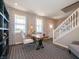 Sunlit office space with a bookshelf, desk, and chair, complemented by stylish curtains and decor at 7628 Big Bend Blvd, Camby, IN 46113