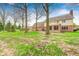 View of the back exterior featuring a mix of siding and brick, and a well maintained green lawn at 7688 Gunsmith Ct, Plainfield, IN 46168
