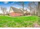 A brick and sided back exterior leads to a green lawn with plenty of natural shade and light at 7688 Gunsmith Ct, Plainfield, IN 46168