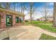 The backyard shows a brick patio with an exterior door to a lush, green yard with mature trees at 7688 Gunsmith Ct, Plainfield, IN 46168