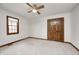 A bright bedroom featuring neutral carpet and a ceiling fan at 7688 Gunsmith Ct, Plainfield, IN 46168