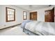 Bedroom with neutral carpeting, two windows, ceiling fan, and wood trim at 7688 Gunsmith Ct, Plainfield, IN 46168