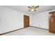 Bedroom featuring a ceiling fan, neutral carpeting, and wood trim at 7688 Gunsmith Ct, Plainfield, IN 46168