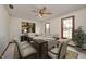 Formal dining room, set for a meal, featuring a decorative ceiling fan and natural light at 7688 Gunsmith Ct, Plainfield, IN 46168