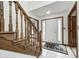 Inviting foyer featuring tiled floors, a wooden staircase, and a white front door with decorative glass panels at 7688 Gunsmith Ct, Plainfield, IN 46168