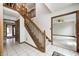 Entryway with tile flooring, wooden staircase, and doorway leading to a living area with a ceiling fan at 7688 Gunsmith Ct, Plainfield, IN 46168