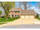 Classic brick home with a well-kept lawn and a convenient three-car attached garage at 7688 Gunsmith Ct, Plainfield, IN 46168