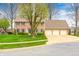 Traditional brick facade with pristine landscaping, three car garage, and new driveway at 7688 Gunsmith Ct, Plainfield, IN 46168