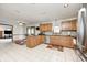Kitchen with wooden cabinets, granite counters, stainless steel appliances, and tile flooring at 7688 Gunsmith Ct, Plainfield, IN 46168