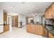 Bright kitchen offering granite countertops, wood cabinets, and tile floors at 7688 Gunsmith Ct, Plainfield, IN 46168