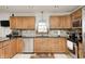 This kitchen is equipped with stainless appliances, dark granite countertops and wood cabinets at 7688 Gunsmith Ct, Plainfield, IN 46168