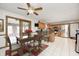 Eat-in kitchen featuring wood cabinets, granite counters, stainless steel appliances, and an adjacent dining area at 7688 Gunsmith Ct, Plainfield, IN 46168