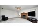 Spacious living room with carpet, a brick fireplace, ceiling fan, and a large television at 7688 Gunsmith Ct, Plainfield, IN 46168