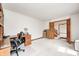 Spacious office features custom wooden built-ins and natural light from the doorway and a clean, neutral carpet at 7688 Gunsmith Ct, Plainfield, IN 46168
