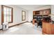 Office with a built-in desk and shelving plus natural light from a large window at 7688 Gunsmith Ct, Plainfield, IN 46168